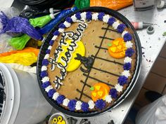 a decorated birthday cake sitting on top of a table next to halloween decorations and candy