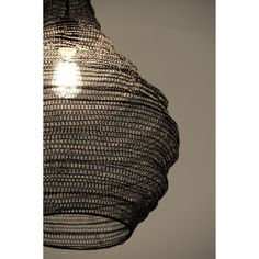 a light that is hanging from the ceiling with mesh coverings on it's sides