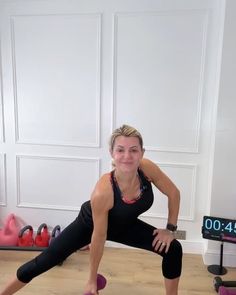 a woman is doing yoga in front of a tv