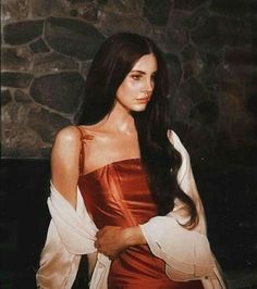 a woman with long black hair wearing a red dress