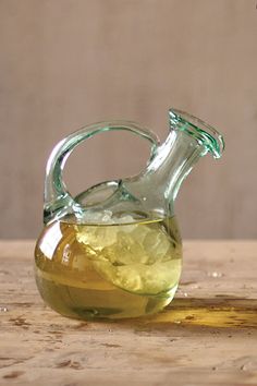 a glass bottle filled with liquid sitting on top of a wooden table