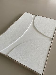 a white box with a curved design on it