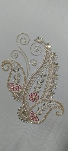 an embroidered design on a white fabric