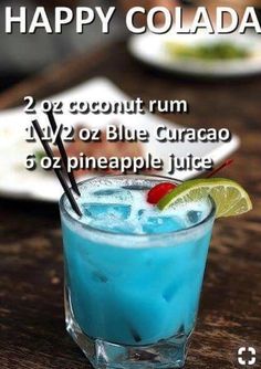 the happy colada cocktail is served in a blue curacao with a lime slice