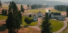 an aerial view of a farm with trees and buildings