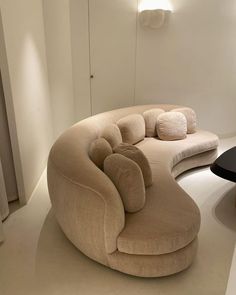 a living room filled with furniture and a round table in front of the couches