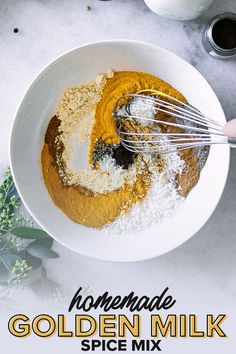 homemade golden milk spice mix in a bowl with whisk and spices on top