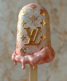 a close up of a cake on a stick with the letter y painted on it