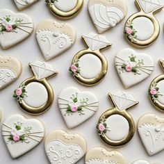 decorated cookies arranged in the shape of wedding rings and heart - shaped cookie cutters