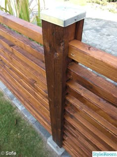 a wooden fence that is next to some grass