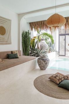 a living room filled with lots of furniture next to a swimming pool on top of a rug