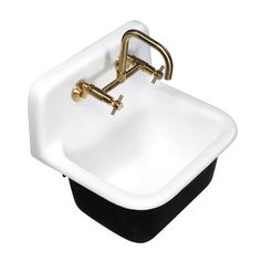 a white sink with gold faucet and black base