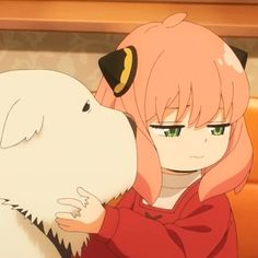 a girl hugging a white dog with her face close to the camera while she is wearing a red sweater