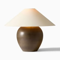 a brown table lamp with a white shade on it