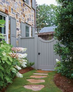 a stone path leading to a brick house