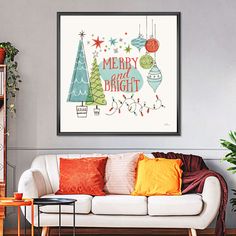 a living room with a white couch and christmas tree art on the wall above it