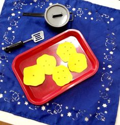 a red tray topped with cut out pieces of food