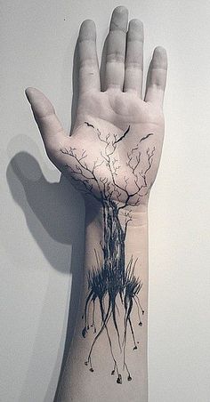 a person's arm with a tattoo on it that has trees growing out of it