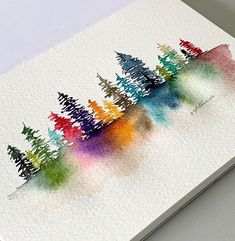 a watercolor painting of trees on a white paper with blue, green, yellow and red colors