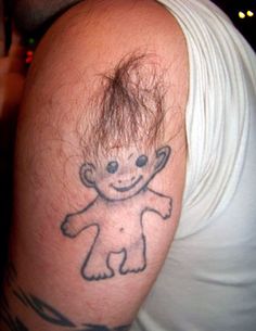 a man with a tattoo on his arm that has a drawing of a baby in it