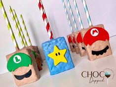 some cupcakes made to look like super mario bros characters with candles in them