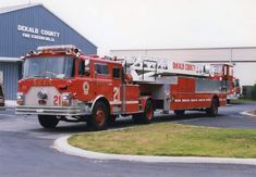 two fire trucks parked in front of a building