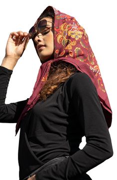 a woman wearing sunglasses and a scarf on her head