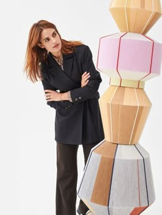 a woman standing next to a large wooden object that looks like he is leaning on it