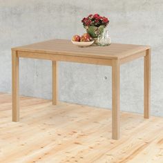 a wooden table with a bowl of fruit on it