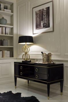 a black and gold table with a lamp on it