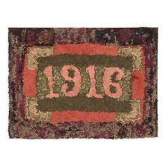 an old rug with the number nineteen thirteen on it's center and two different colors