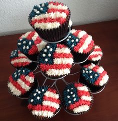 cupcakes with red, white and blue frosting are stacked on top of each other