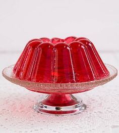 a red cake dish sitting on top of a white table