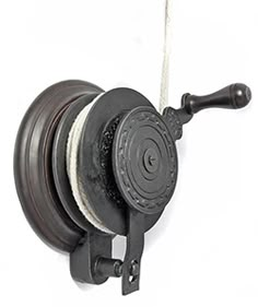 an old black door knob with a rope hanging from it's center and two pulleys on each side