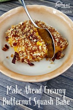 a close up of a plate of food with a spoon in it and the words make ahead creamy butternut squash bake