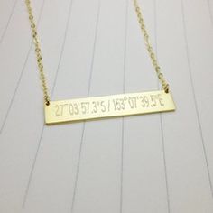 a gold plated necklace with the date on it