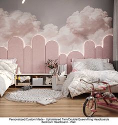 two beds in a room with pink walls and clouds painted on the wall behind them