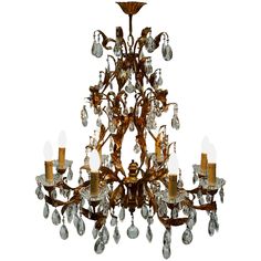 an antique chandelier with crystal drops hanging from it's center, on a white background