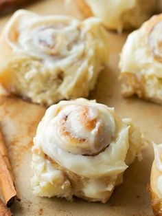 cinnamon rolls with icing and cinnamon sticks