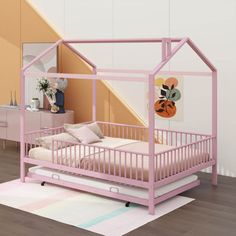 there is a pink bed with a house shaped frame on the top and bottom bunk