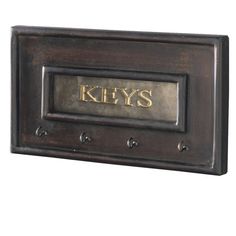 a metal plaque with the word keys on it's front and two brass letters on each side