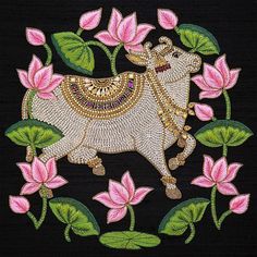 an embroidered bull with flowers and leaves on it's back, in the middle of a black background