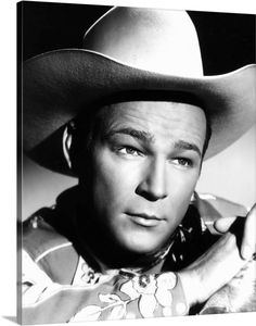 a black and white photo of a man wearing a cowboy hat