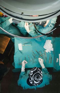 medical personnel in scrub suits and surgical equipment