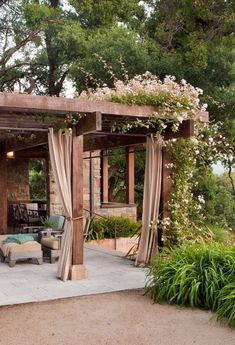 an outdoor living area with patio furniture and flowers