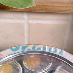 three spice jars sitting on top of a plate