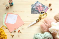 the craft supplies are laid out on the table to be used for crafts and knitting