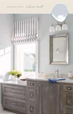 a bathroom with two sinks and a large mirror on the wall next to a window