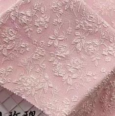 pink lace fabric with flowers on it