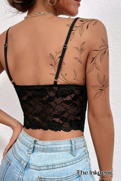 the back of a woman's top with tattoos on it